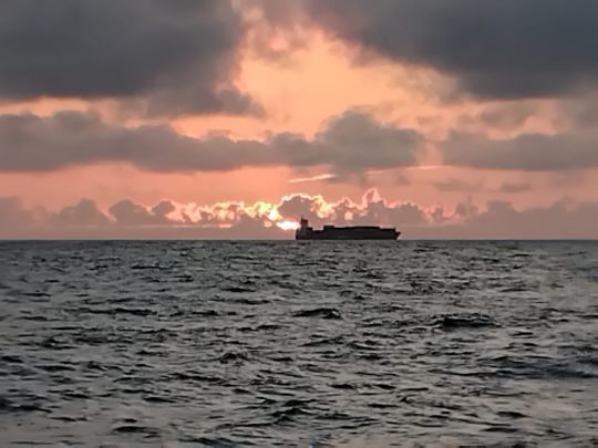 Passage d'un cargo dans le coucher de soleil en plein golfe de Gascogne