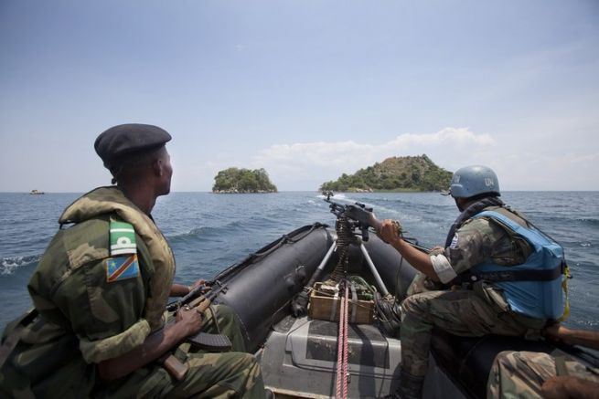 A MONUSCO peacekeeper and a soldier of the Congolese National Army (FARDC) are on patrol on Lake Tanganyika