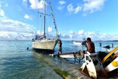 Preparing a sailing boat for a voyage at the bottom of a Polynesian atoll